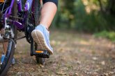 Female cyclist cycling in countryside Female cyclist cycling in countryside