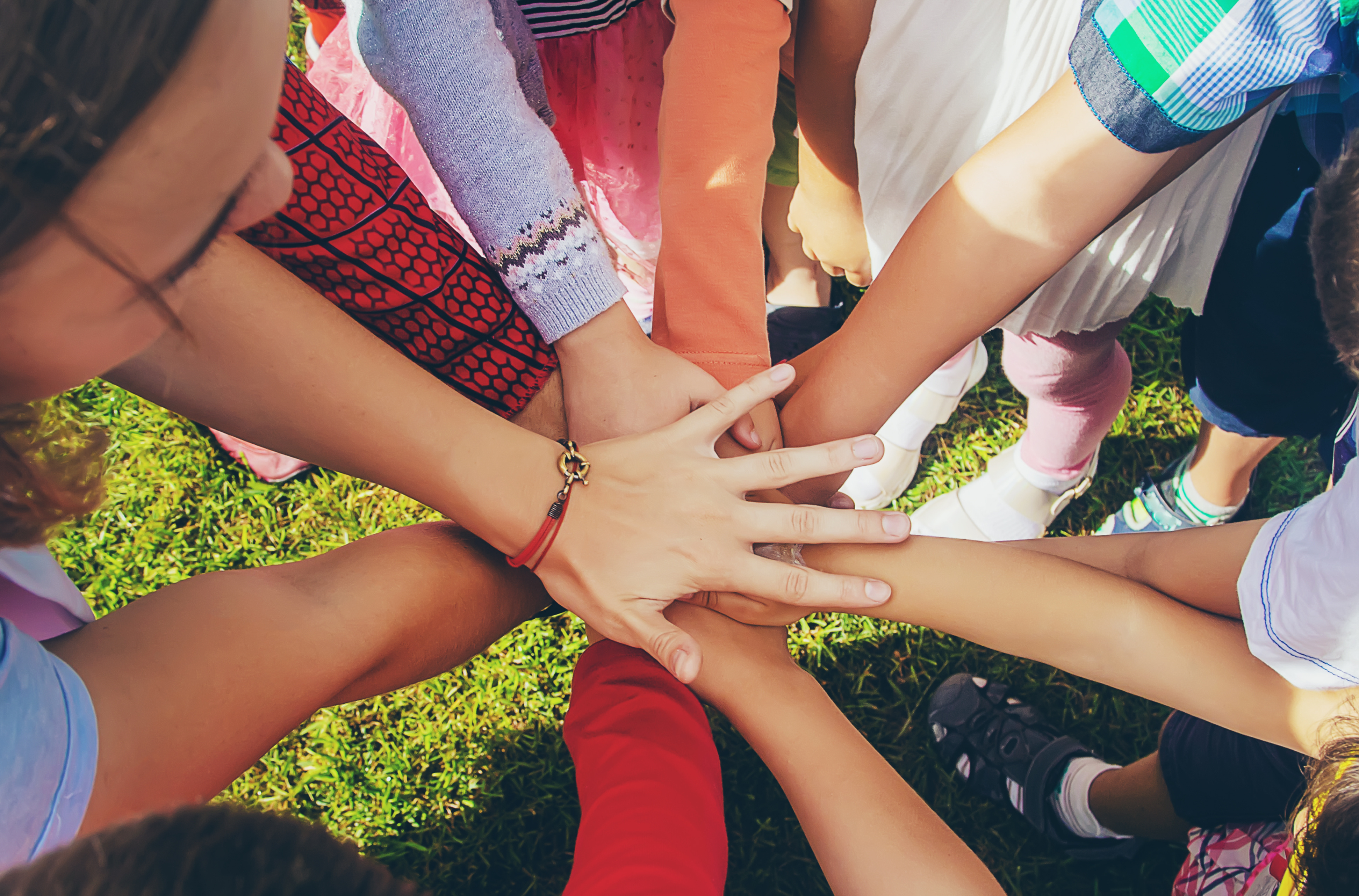 children folded their hands together, play on the street. Selective focus.