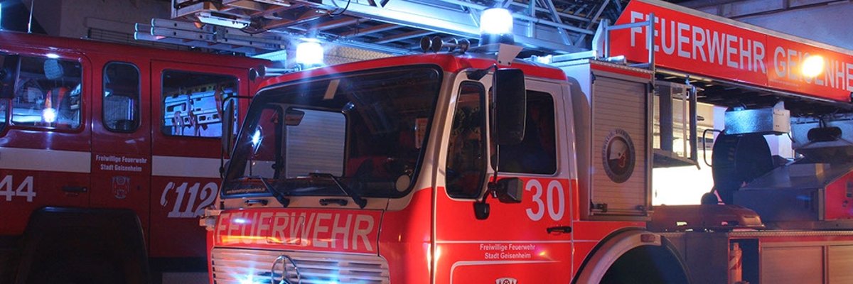 Feuerwehrauto mit Blaulicht, bei Nacht